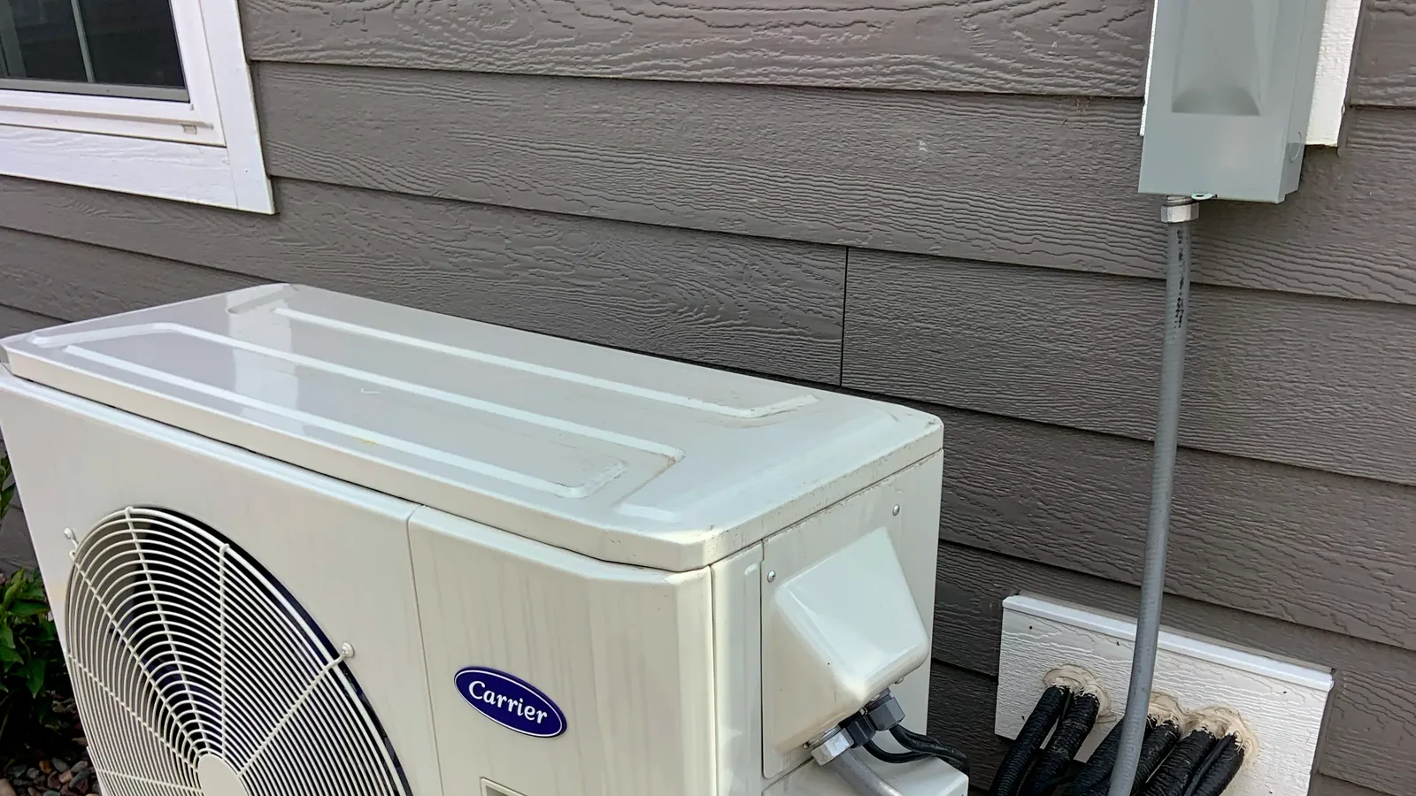 Air source heat pump outdoor unit in a residential setting